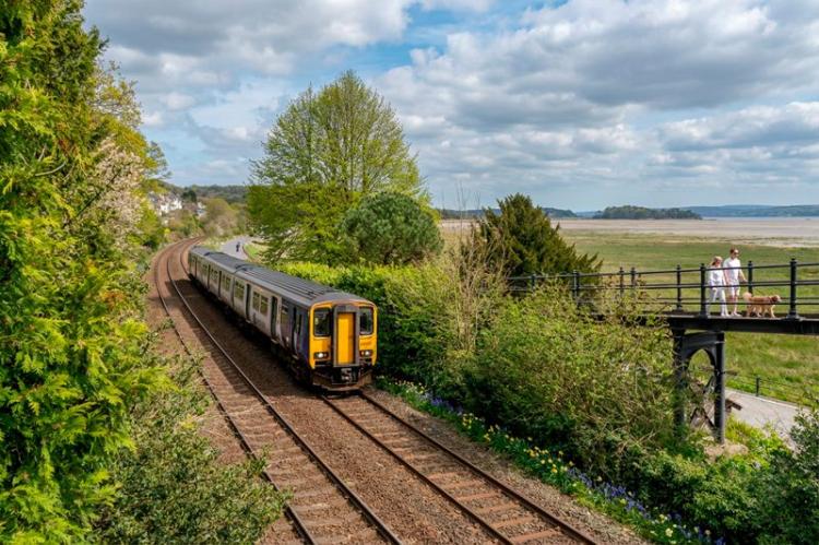 Train travelling through Kents Bank, Grange over Sands in Cumbria